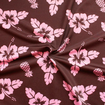 Tela de lycra estampado marrón y rosa con flor de hibiscus
